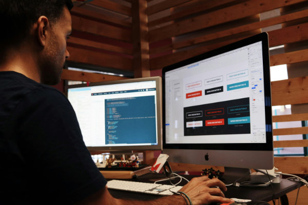 Two colleagues collaborating on a project at a desk